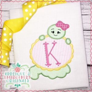 1909 Bookworm Girl with Oval Monogram Frame Applique Design